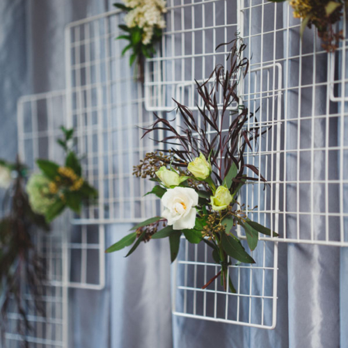 Wall of wedding floral bouquets with white roses, by Oceanside florist Petal and Kettle, Vancouver Island