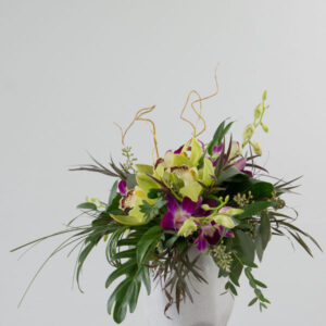 Flower arrangement by Parksville florist Petal and Kettle, yellow and purple tropical flowers and orchids