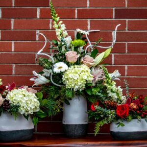 festive vase arrangment for Christmas, assembled by Oceanside florist Petal and Kettle
