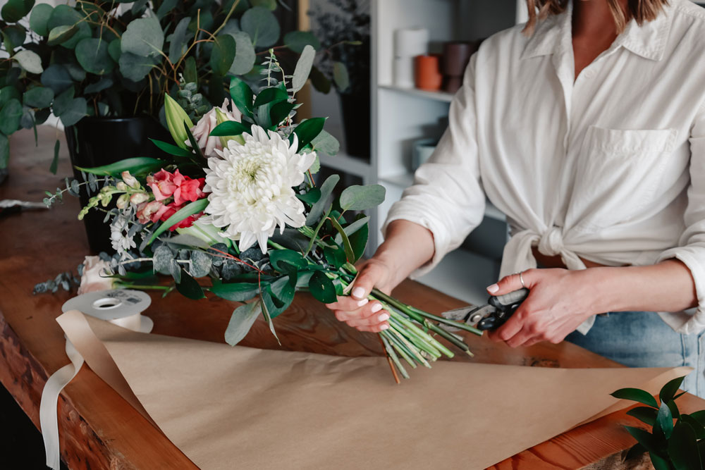 flowers being wrapped for delivery at Petal and Kettle Parksville